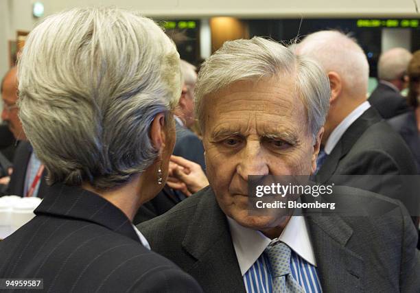 Jean-Claude Trichet, president of the European Central Bank , right, listens to Christine Lagarde, French economy minister, at an EcoFin meeting of...