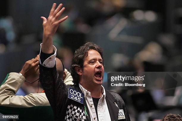 Trader Bryan Cooley signals out an order in the S&P 500 pit at CME Group Inc.'s Chicago Board of Trade shortly after the Federal Open Market...