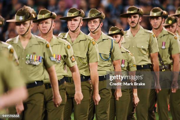 Members of the Australian armed forces march during the Anzac Day ceremony before round five AFL match between the Port Adelaide Power and the...