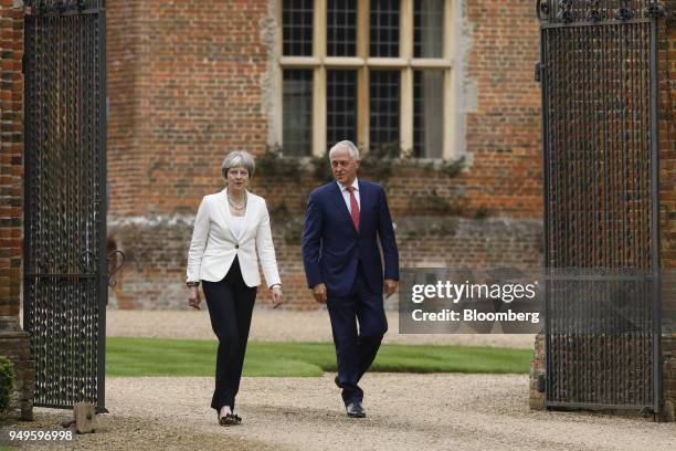 Theresa May, U.K. Prime minister, left, walks with Malcolm Turnbull, Australia's prime minister, during a meeting at Chequers in Aylesbury, U.K., on...