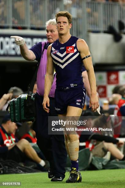 Matt Taberner of the Dockers leaves the ground injured during the round five AFL match between the Fremantle Dockers and the Western Bulldogs at...