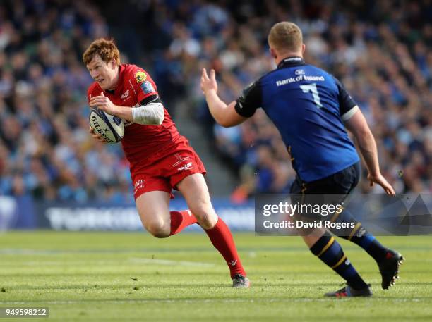 Rhys Patchell of the Scarlets takes on Dan Leavy during the European Rugby Champions Cup Semi-Final match between Leinster Rugby and Scarlets at...