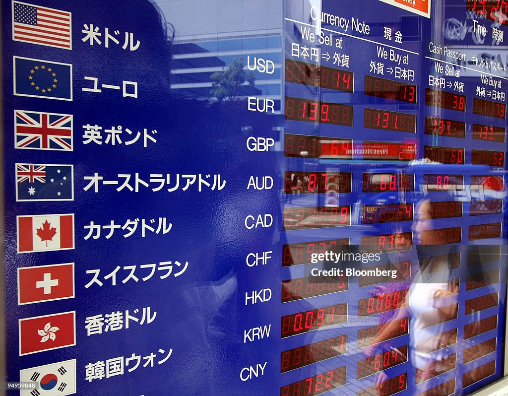 A woman is reflected in an electronic board displaying the c