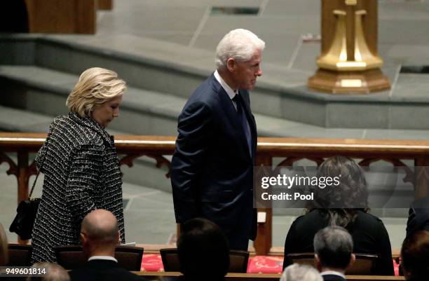 Accompanied by his wife, Hillary Clinton,left, former President Bill Clinton arrives at St. Martin's Episcopal Church for a funeral service for...