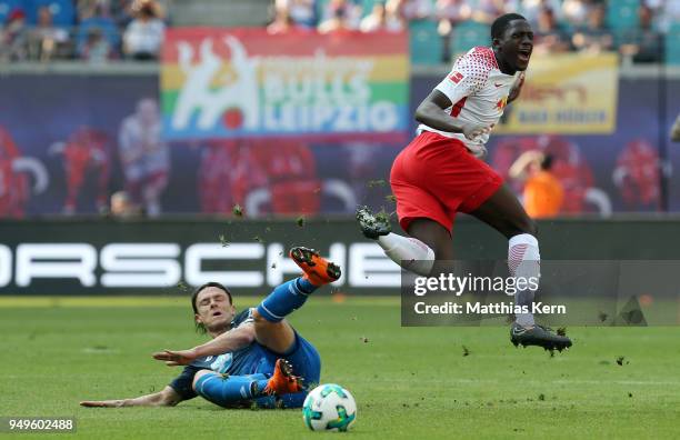 Ibrahima Konate of Leipzig is attacked by Nico Schulz of Hoffenheim during the Bundesliga match between RB Leipzig and TSG 1899 Hoffenheim at Red...