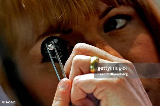 Beth Leinonen, a gemologist, examines a diamond for imperfections at a store run by Brilliant Earth, which uses conflict-free diamonds from Canadian...