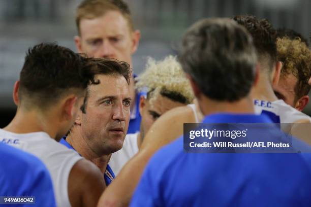 Luke Beveridge, Senior Coach of the Bulldogs, addresses the players at the three-quarter time break during the round five AFL match between the...