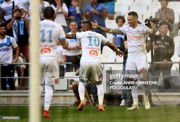 Olympique de Marseille's Argentinian forward Lucas Ocampos celebrates with teammates after scoring a goal on April 21, 2018 at the Velodrome stadium...
