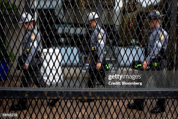 Police officers walk past a security gate near the David L. Lawrence Convention Center before the start of the Group of 20 summit in Pittsburgh,...