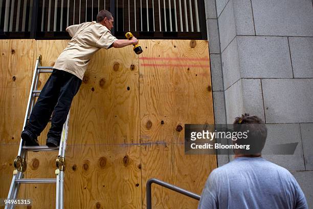 Man boards up windows outside the Catholic Charities Diocese before the start of the Group of 20 summit in Pittsburgh, Pennsylvania, U.S., on...