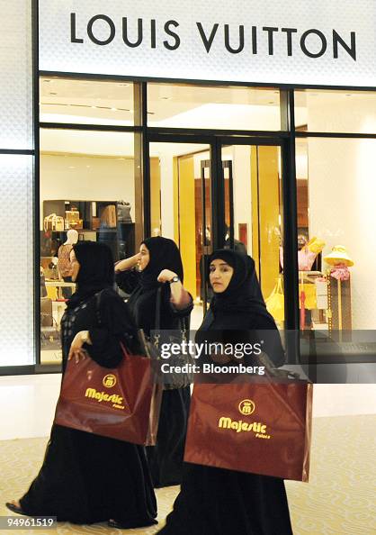 Women shoppers walk past a Louis Vuitton store at the Dubai Mall News  Photo - Getty Images