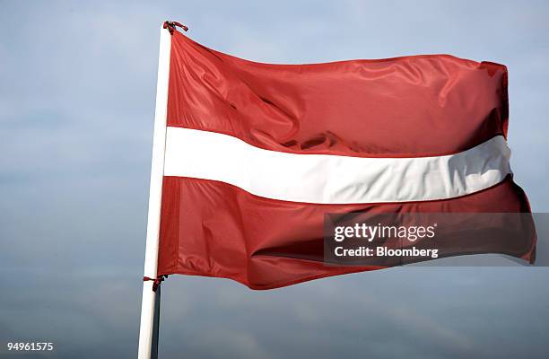 The Latvian national flag flies from a flagpole in the capital of Riga, Latvia, on Saturday, June 13, 2009. Latvia and the International Monetary...