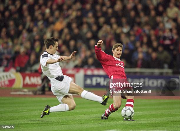 Michael Tarnat of Bayern Munich crosses the ball past Gary Neville of Manchester United to make the opening goal during the UEFA Champions League...