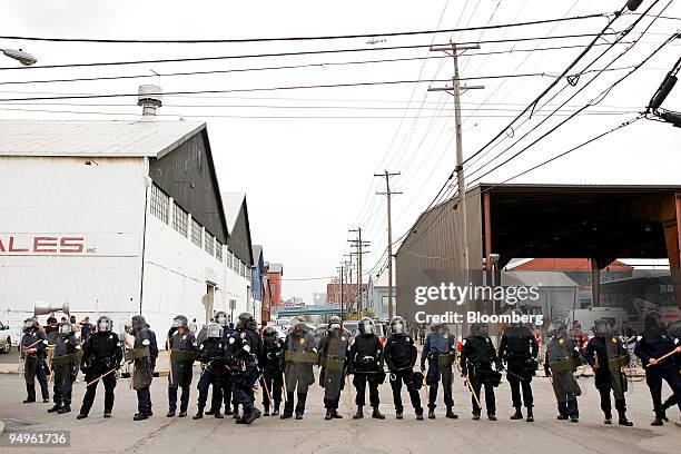 Officers dressed in riot gear monitor protests during day one of the Group of 20 summit in Pittsburgh, Pennsylvania, U.S., on Thursday, Sept. 24,...