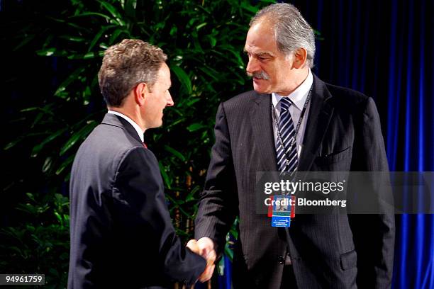 Timothy Geithner, U.S. Treasury secretary, left, greets John Lipsky, first deputy managing director of the International Monetary Fund , at the...