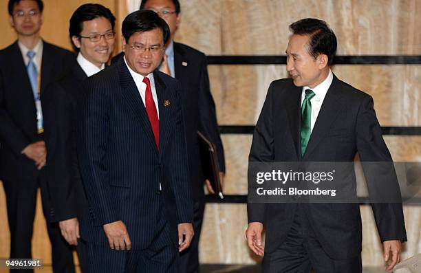 Bouasone Bouphavanh, Laos prime minister, second from right, arrives for a meeting with Lee Myung Bak, South Korea's president, at the ASEAN-Republic...