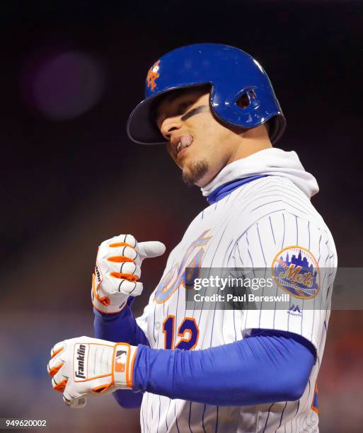 Juan Lagares of the New York Mets reacts and gestures to his teammates in the dugout after he laid down a bunt for a single in an MLB baseball game...