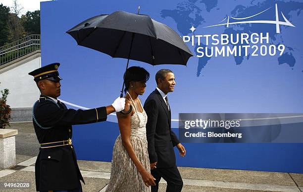 President Barack Obama, right, arrives with U.S. First lady Michelle Obama, to the welcoming dinner for the Group of 20 leaders on day one of the...