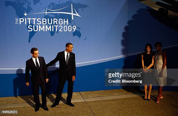 President Barack Obama, second from left, greets Nicolas Sarkozy, president of France, left, as U.S. First lady Michelle Obama, right, and Carla...