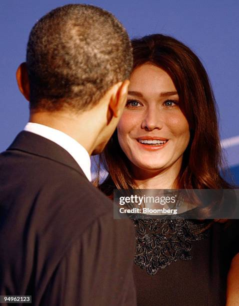 President Barack Obama, left, greets Carla Bruni, France's first lady, to the welcoming dinner for Group of 20 leaders on day one of the G-20 summit...