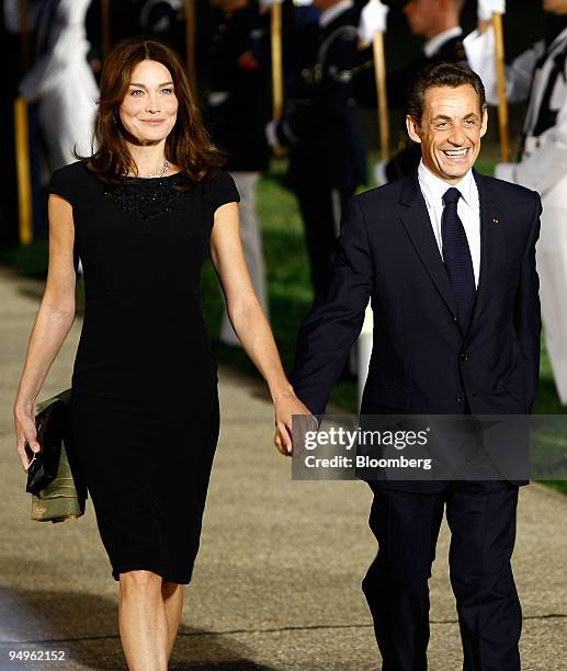 Nicolas Sarkozy, president of France, right, arrives with his wife Carla Bruni to the welcoming dinner for the Group of 20 leaders on day one of the...