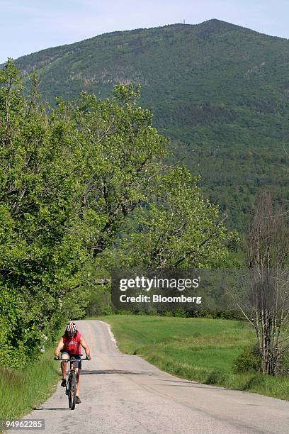 Cyclist makes his way up a hill near Burke Mountain on the Kingdom Trails in East Burke, Vermont, U.S., on Wednesday, June 17, 2009. Kingdom Trails...