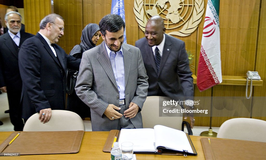 Mahmoud Ahmadinejad, president of Iran, prepares to sign a g