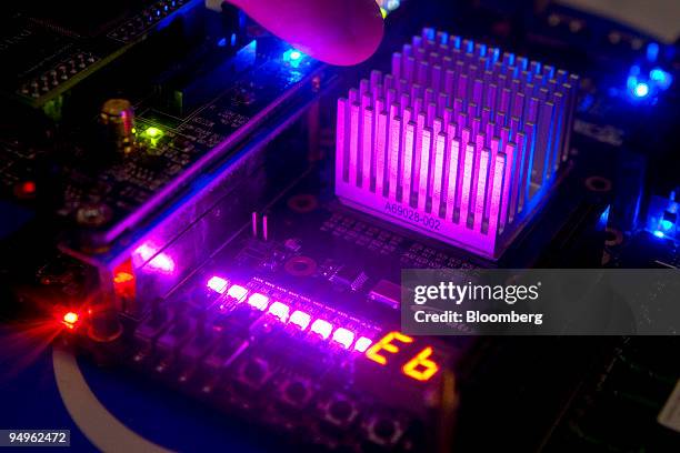 An Intel researcher points to the heat sink of a programmable computer vision accelerator for future smart phones during the annual Research at Intel...