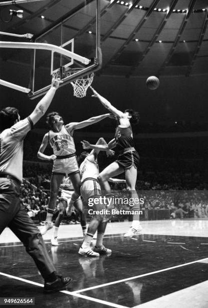 Knicks' Phil Jackson is caught red-handed fouling the Buffalo Braves John Hummer in the act of shooting and the referee is right in there to award...