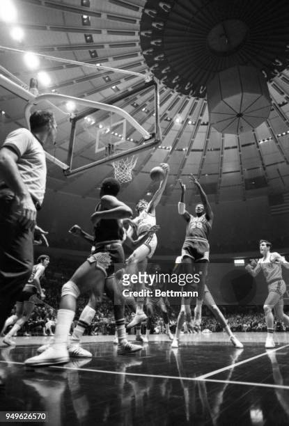 In the center of a semicircle of players Knicks' Phil Jackson and Phoenix's Paul Silas battle for a rebound during Madison Square Garden play. New...