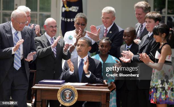 President Barack Obama, center, applauds along with members of Congress, his Cabinet and children representing the Campaign for Tobacco Free Kids,...