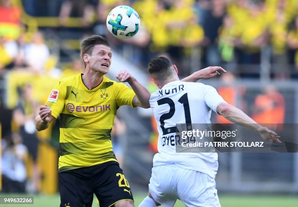 Dortmund's Polish defender Lukasz Piszczek and Leverkusen's German midfielder Dominik Kohr vie for the ball during the German first division...