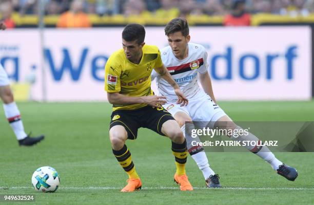 Leverkusen's Greek defender Panagiotis Retsos and Dortmund's US midfielder Christian Pulisic vie for the ball during the German first division...