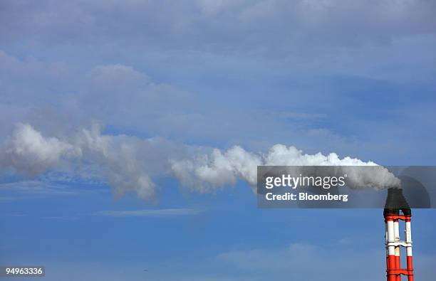 Smoke billows out of the chimney at a plant in Kamisu City, Ibaraki Prefecture, Japan, on Tuesday, July 7, 2009. Prime Minister Taro Aso pledged on...
