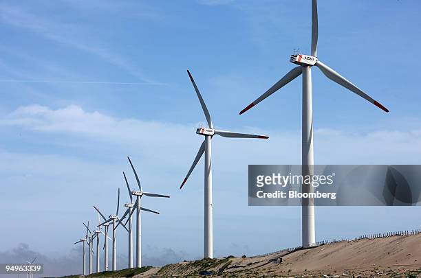 Wind turbines stand at the Hasaki Wind Farm in Kamisu City, Ibaraki Prefecture, Japan, on Tuesday, July 7, 2009. Prime Minister Taro Aso pledged on...