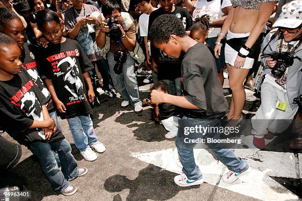Crowd gathers around kids dancing to "Beat It" outside the Staples Center during a memorial service for Michael Jackson in Los Angeles, California,...