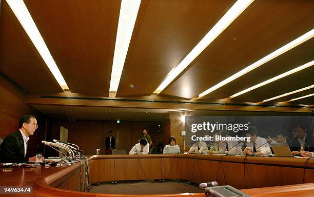 Masaaki Shirakawa, governor of the Bank of Japan, left, speaks during a news conference at the central bank's headquarters, in Tokyo, Japan, on...