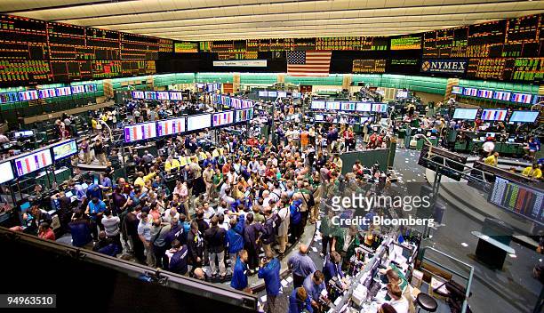 Commodity futures and options traders work on the floor of the New York Mercantile Exchange in New York, U.S., on Tuesday, July 7, 2009. U.S....