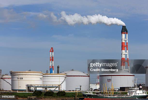 Exhaust billows out of a chimney at an oil refinery in Kamisu city, Ibaraki prefecture, Japan, on Tuesday, July 7, 2009. Prime Minister Taro Aso...