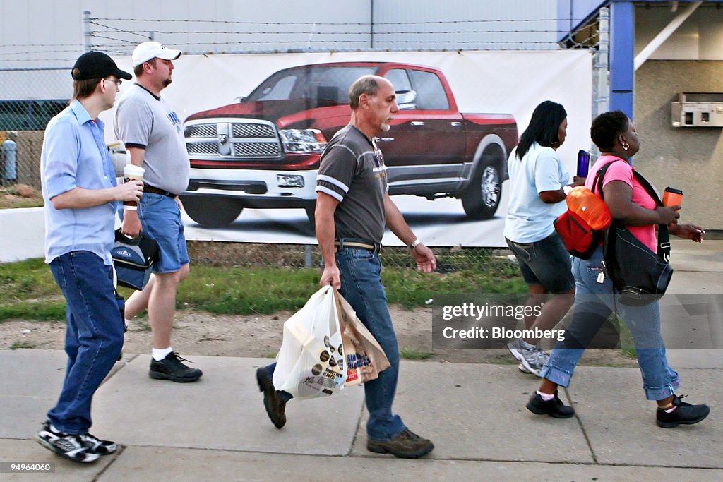 Workers arrive for the morning shift at the reopened Chrysle
