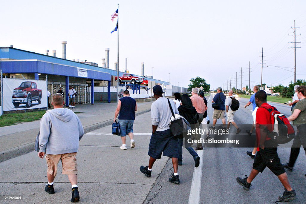 Workers arrive for the morning shift at the reopened Chrysle