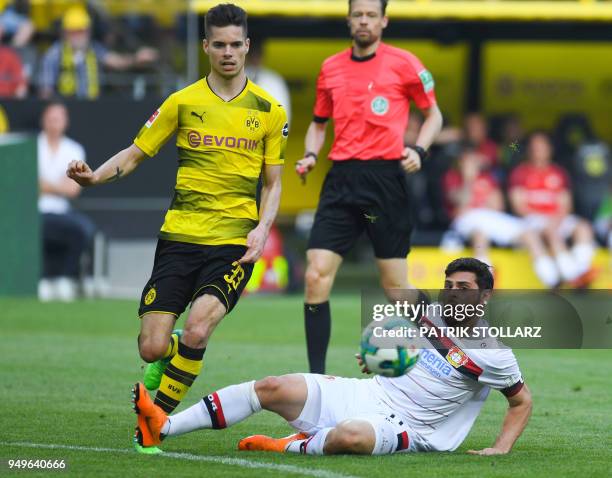 Dortmund's German midfielder Julian Weigl and Leverkusen's German forward Kevin Volland vie for the ball during the German first division Bundesliga...