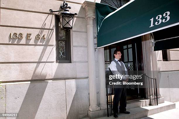 Doorman who declined to be identified stands outside 133 East 64th Street, a building that houses the penthouse apartment belonging to Bernard and...