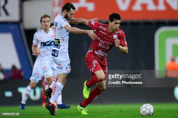 Hamdi Harbaoui forward of SV Zulte Waregem holds off the challenge of Idir Ouali forward of KV Kortrijk during the Jupiler Pro League Play - Off 2A...