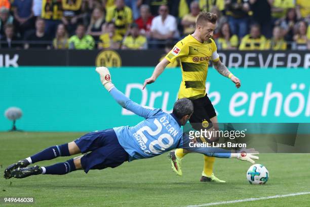Marco Reus of Dortmund goes past goalkeeper Ramazan Oezcan of Bayer Leverkusen to score a goal to make it 2:0 during the Bundesliga match between...