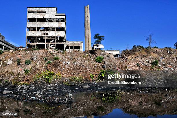 An abandoned building and garbage sit along the banks of the Riachuelo River near Buenos Aires, Argentina, on July 2, 2009. The World Bank in June...