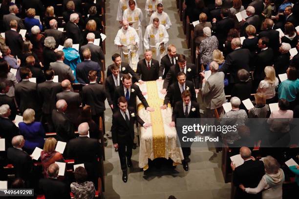 Pallbearers guide the coffin of former first lady Barbara Bush during funeral services at St. Martin's Episcopal Church on April 21, 2018 in Houston,...