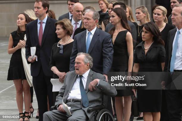 Former president George H.W. Bush and son, former president George W. Bush, watch with family as the coffin of former first lady Barbara Bush is...