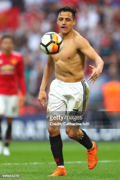 Alexis Sanchez of Manchester United plays on the pitch after his sides victory in The Emirates FA Cup Semi Final match between Manchester United and...