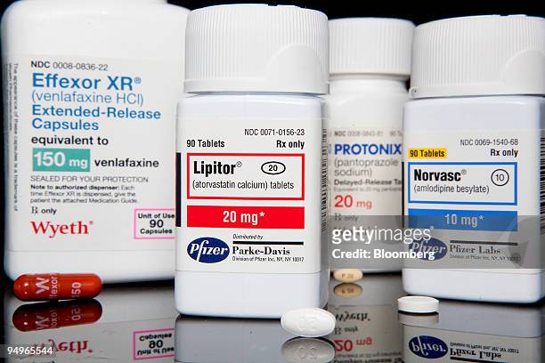 Pfizer Inc.'s cholesterol drug Lipitor, the world's best selling drug, center, and Pfizer's Norvasc blood pressure medicine, right, are arranged for...